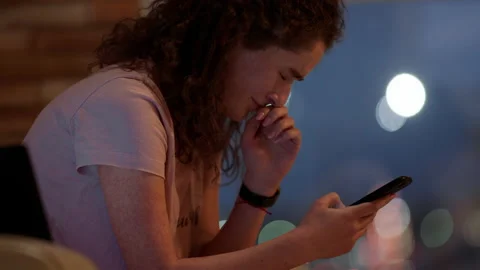 Crying lady in the living room while sitting on the sofa she search something on Video stock 164848084