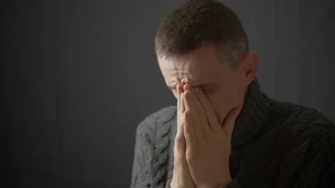 The crying man covers his face with his hands. Depressive state. Stock Footage 163963687