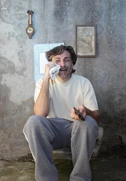 Crying man with remote control Stock Photos