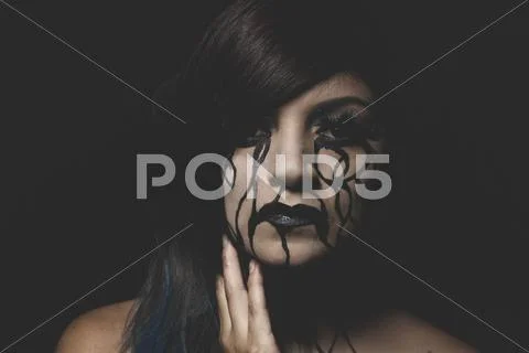 Crying, representation of sadness, beautiful woman with painted tears on the Stock Photos