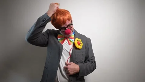 Crying sad man removing his clown costume in studio Video stock 323804410