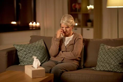 Crying senior woman wiping tears with paper tissue Stock Photos
