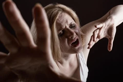 Crying woman on a dark background Stock Photos