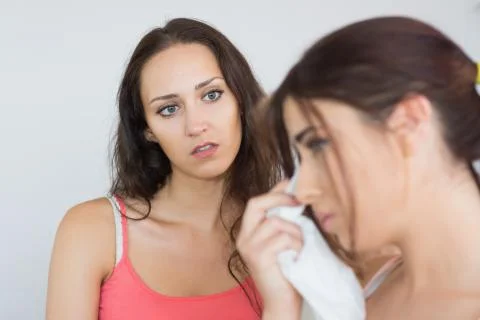 Crying woman sitting with her friend Stock Photos