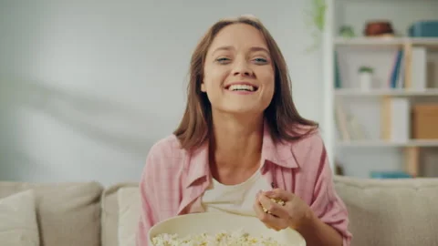 A Crying Young Woman Eating Popcorn and ... | Stock Video | Pond5