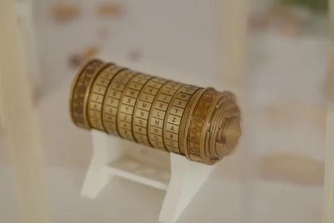 Cryptex resting on white stand showing alphabet letters, concept of encrypt.. 스톡 사진