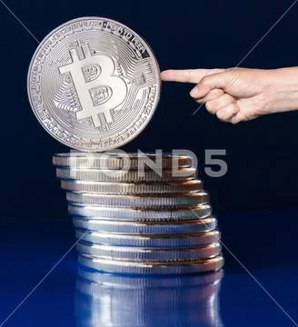 Crypto bitcoin on a blue background - decline Stock Photos