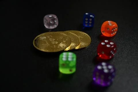 Crypto Coins and Dice Representing Financial Risk Stockfoto's