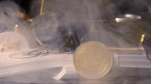 Crypto coins and stacks of dollar bills  with diffuse smoke Stock Footage 217947217