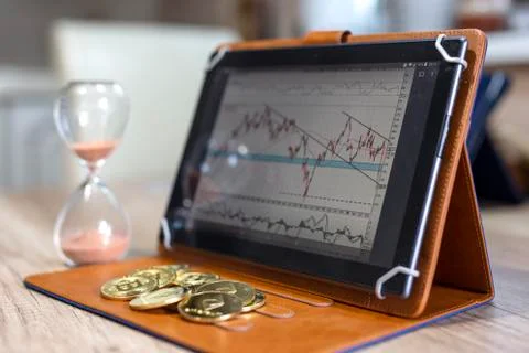 Crypto currency and graph analysis on tablet Stock Photos
