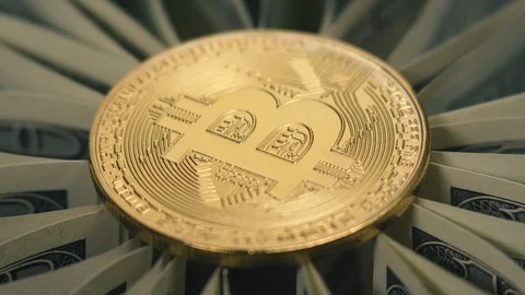 Crypto currency is bitcoin. BTK shoot close up. Bitcoin rotates on dollars Video stock 88856816