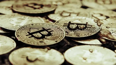 Crypto currency Bitcoin extreme close up stock footage. Golden BTC coins.  Stock Footage 253576659