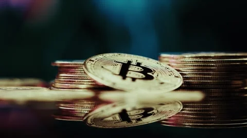Crypto currency Bitcoin extreme close up stock footage. Golden BTC coins.  Stock Footage 253577040