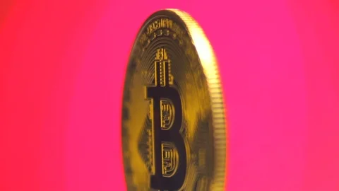 Crypto currency, bitcoin gently rotates on a pink background. BTC, Bit Coin Stock Footage 88614867