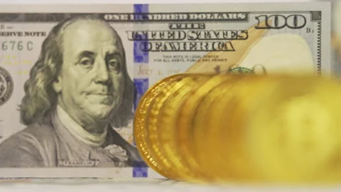 Crypto currency, bitcoin. Refocusing from dollar banknote to bitcoin coin Stock Footage 195730807