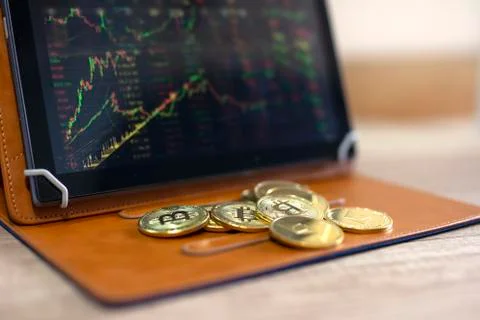 Crypto currency bitcoin on table with tablet Stock Photos