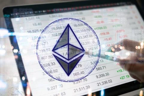 Crypto currency etherium symbol while using computer laptop background diagra Stock Photos