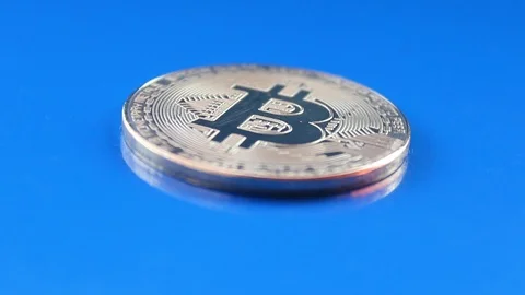 Crypto currency isolated silver bitcoin rotates on a blue background 스톡 동영상 87681017