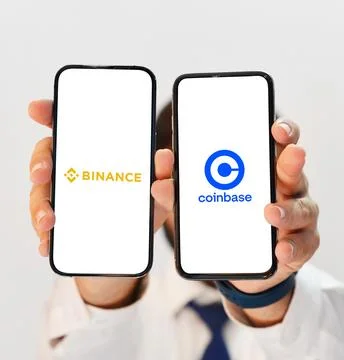 Crypto dealing platform Binance and Coinbase side by side comparison concept Stock Photos