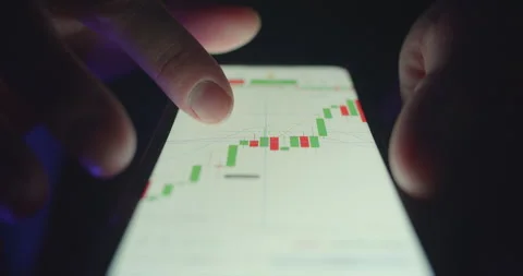Crypto trader analyzing market trends and making investment decisions 動画素材 303431230