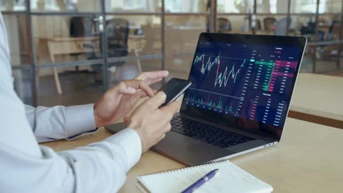Crypto trader broker using phone app analyzing stock market on cell phone. Stock Footage 164101779