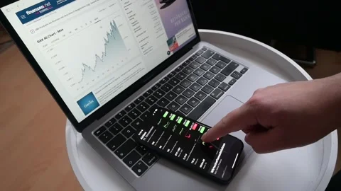 Crypto Trader Broker Using Phone App Analyzing Stock Market On Cell Phone. Stock Footage 258247234
