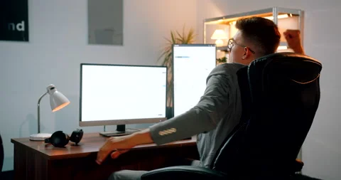 Crypto trader celebrating for making good profits while daytrading in his of Stock-Footage 160986840