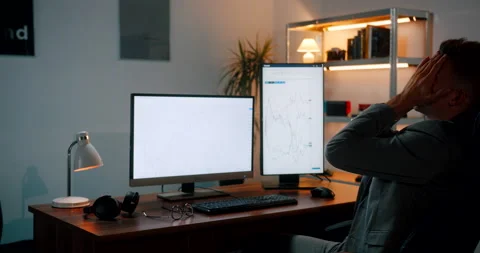 Crypto trader frustrated while daytrading on his office computer Stock-Footage 160987225