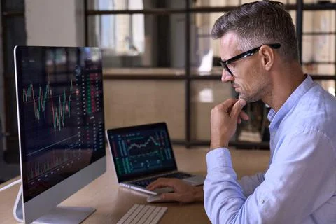 Crypto trader investor using computer cryptocurrency stock market trading chart. Stock Photos