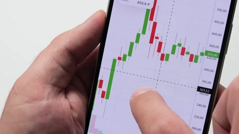 Crypto trader investor using smart phone app financial stock trade market Stock Footage 292388283