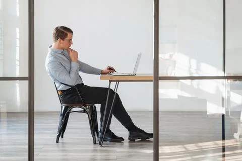 Crypto trader with laptop analyzing consequences of global recession on stock Stock Photos