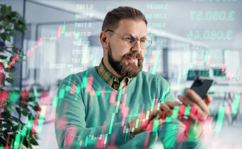 Crypto trader with smartphone Stock Photos