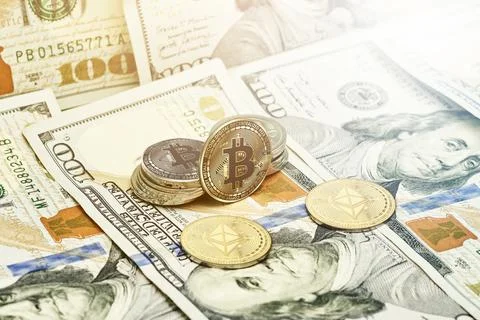 Cryptocoins and pile of us dollars Stock Photos