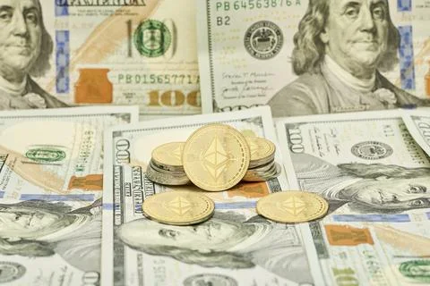 Cryptocoins and pile of us dollars Stock Photos