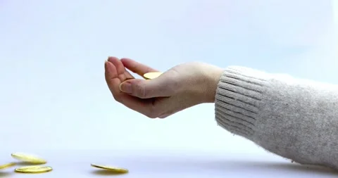 Cryptocoins, Bitcoin or BTC being dropped in a woman's hand, depicting earning Stock Footage 220561190