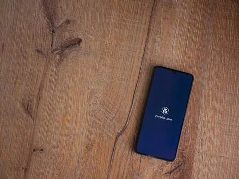 Crypto.com app launch screen on smartphone on wooden background Stock Photos