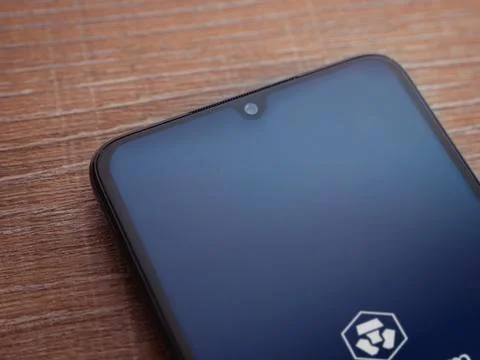 Crypto.com app launch screen on smartphone on wooden background Stock Photos