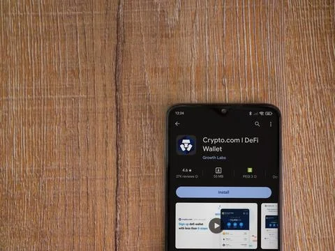 Crypto.com app play store page on smartphone on wooden background Stock Photos