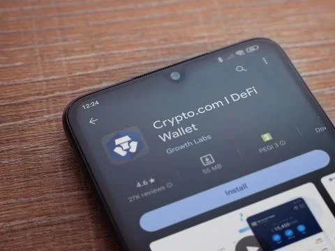 Crypto.com app play store page on smartphone on wooden background Stock Photos