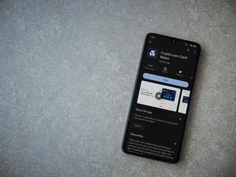 Crypto.com app play store page on smartphone on ceramic stone background Stock Photos