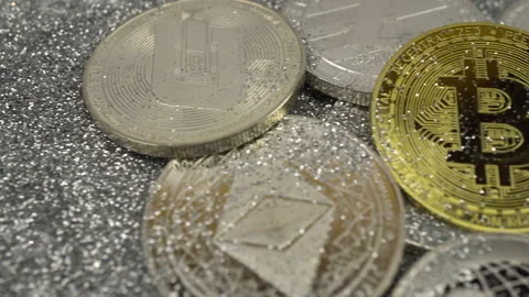 Cryptocurrencies lie on silver sequins. Real coins. The camera moves from left Stock Footage 155356745