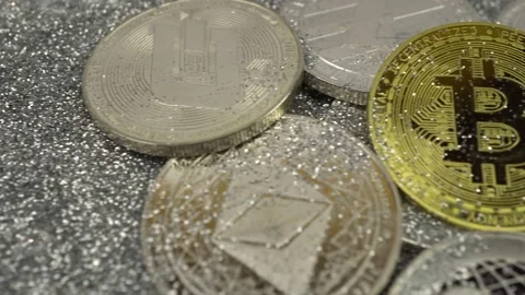 Cryptocurrencies lie on silver sequins. Real coins Stock Footage 155544118