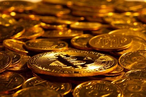 Cryptocurrency Bitcoin against the background of many other coins in hard light Stock Photos