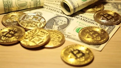 Cryptocurrency Bitcoin and dollars. Bit coins and cash Stock Footage 83212763