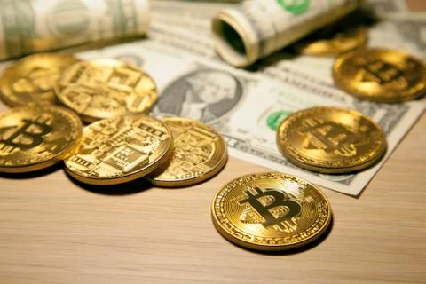 Cryptocurrency Bitcoin And Dollars. Bit Coins And Cash Stock Photos
