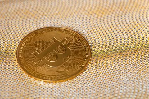 Cryptocurrency Bitcoin on golden background Stock Photos