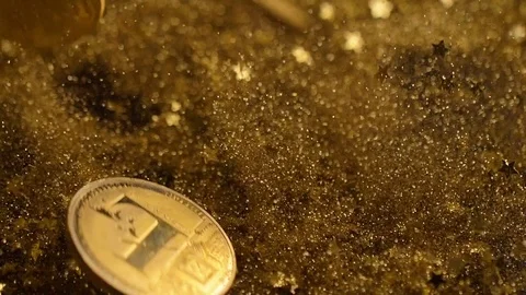 Cryptocurrency Coins Fall down Jump among Golden Dust Macro Vídeos de archivo 83720986