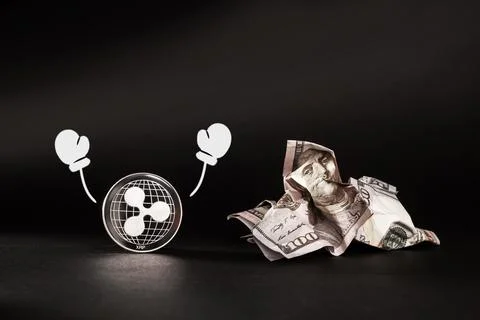 Cryptocurrency defeated the dollar. Battered dollar. Ripple cryptocurrency Stock Photos