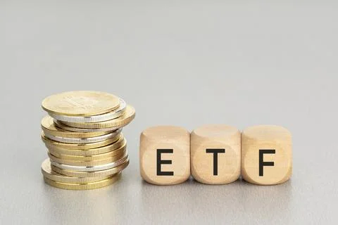 Cryptocurrency ETF concept. Stacked crypto coins and wooden blocks with text. Stock Photos
