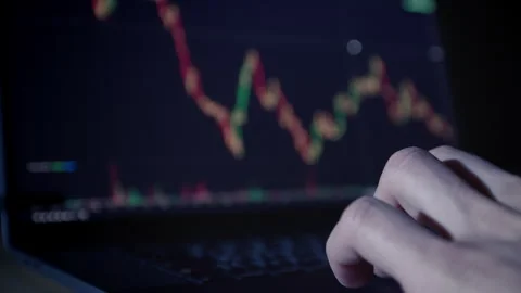 Cryptocurrency exchange on a laptop screen. Hand on keyboard. Close-up. Trading  Stock-Footage 325593351